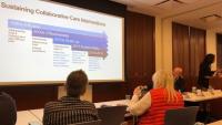 Symposium guests viewing presentation